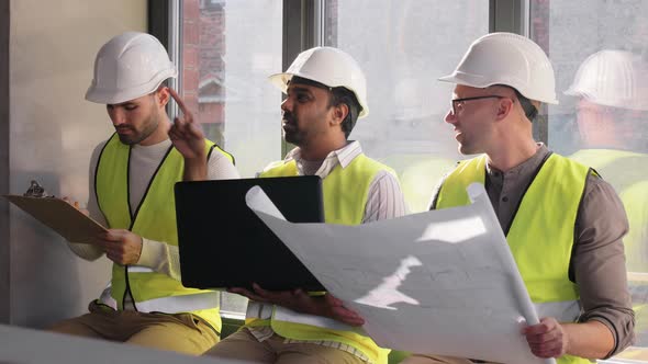 Male Architects in Helmets with Laptop at Office alt