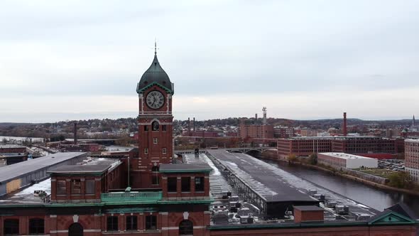 Ayer Mill Clock Tower A Museum Near Merrimack River In Lawrence, Massachusetts, USA. - aerial drone alt