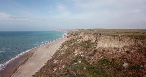 Tropical Beach Video, Aerial Bird Eye View of Blue Foaming Ocean Waves Crushing Against the Coast alt
