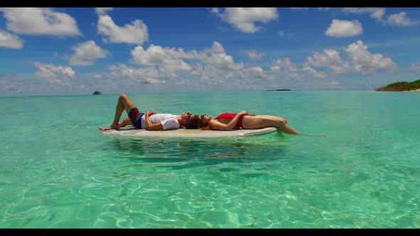 Young couple suntan on tropical resort beach time by blue green ocean and white sand background of t alt