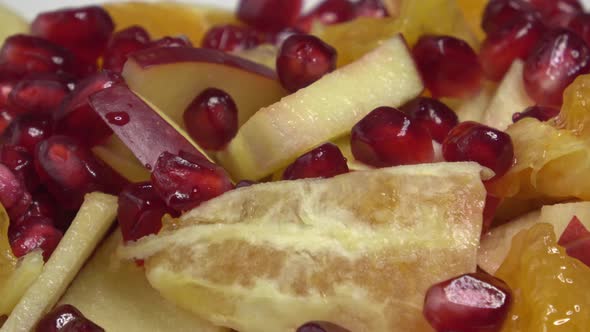 Delicious fruit salad with fresh fruit. Pomegranate, orange, apple