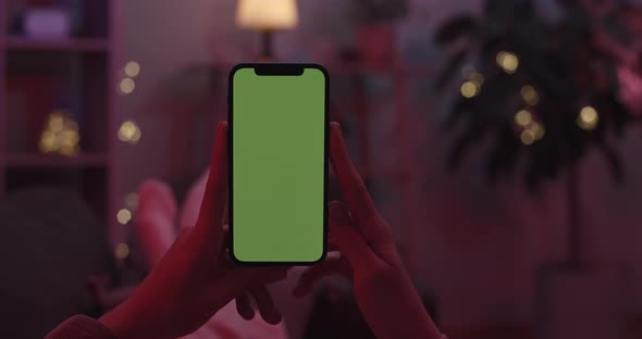 Woman Holding Smartphone with Chroma Key Screen alt