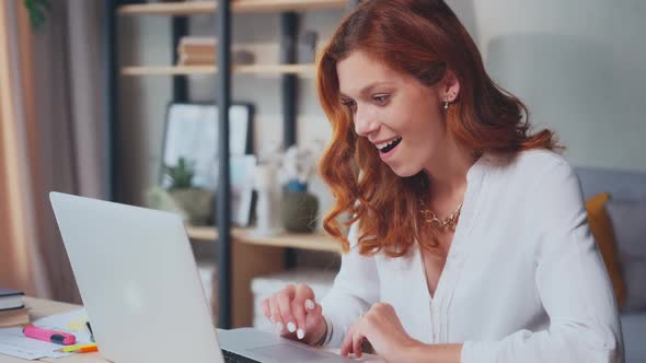 Overjoyed Caucasian Woman Celebrating Rejoices at News or Message on Laptop alt