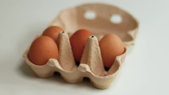 Brown Organic Chicken Eggs in a Brown Paper Tray Placed on White Table