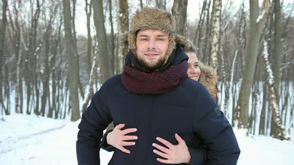 Woman Hugging His Close Up in Snowcovered Forest alt