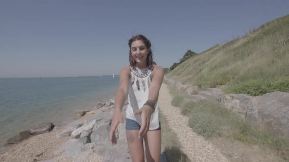 POV Shot of Girl Pulling Boyfriend Along The Beach His Hand in Slowmotion - Ungraded alt