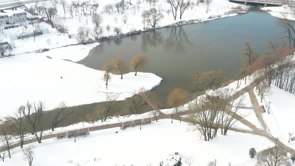 An Island on a Lake with a Bridge in the Winter Loshitsky Park alt