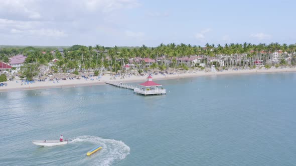 Aerila view of cruising speedboat and Bahia Principe Grand La Romana Villa with private beach and je alt