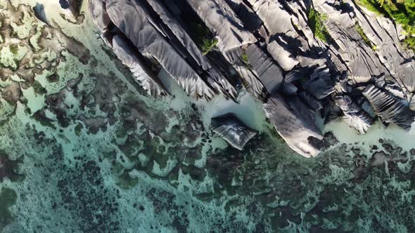 big rocks in the blue ocean from above