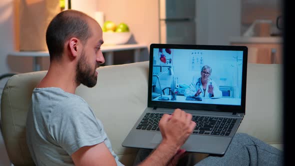 Caucasian Male Chatting with Physician Doctor During Online Telemedicine Consultation alt