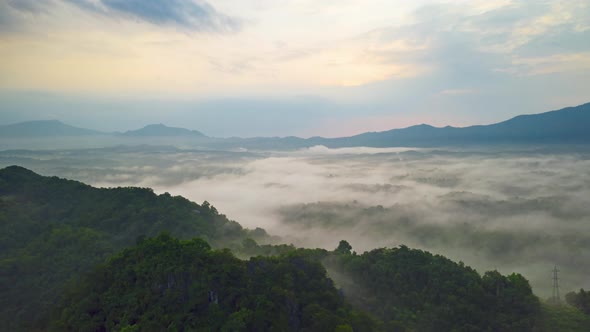 Morning time during sunrise with fog above the mountain, alt