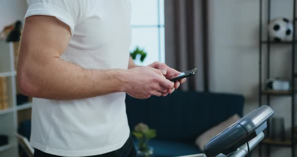 Guy in Sportswear Exercising on Running Track During Morning Workout at Home alt