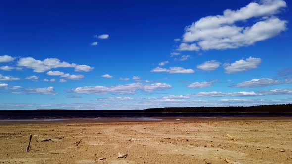 Sandy Beach and the Shore of the Gulf of Finland with Blue Sky
