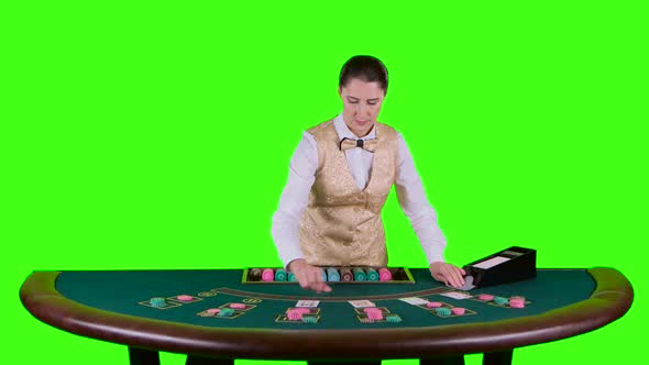 Casino Croupier Standing Behind The Semicircular Table In A White Shirt Takes The Cards From Card Kinomaster