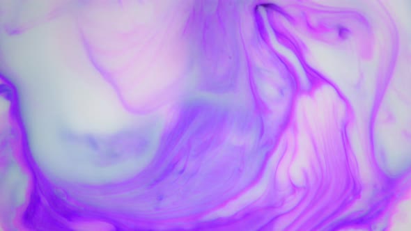 Ink in Water. Purple Ink Reacting in Water Creating Abstract Background.