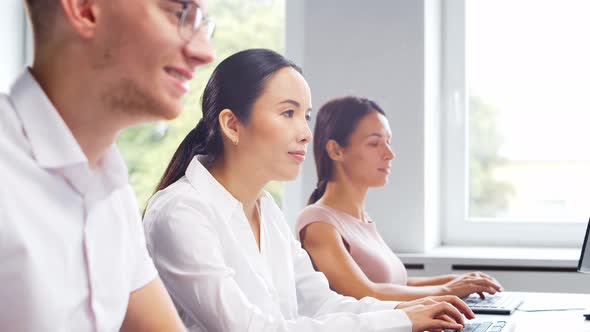 Diverse team of young professionals is working in the phone support office. alt