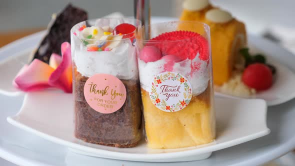 Selection of Sweets Cakes Chocolate Cake and Chocolate Brownie on White Plate alt