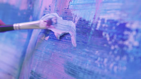A Woman Paint Artist Drawing an Abstract Painting in Blue and Lavender Tones with a Brush and Oil alt