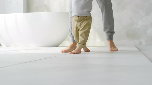 Legs of Cute Baby Learning to Walk alt