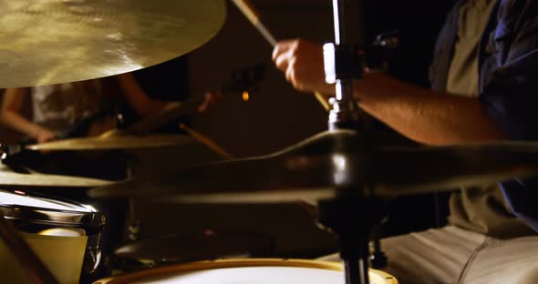 Drummer playing drum in studio alt