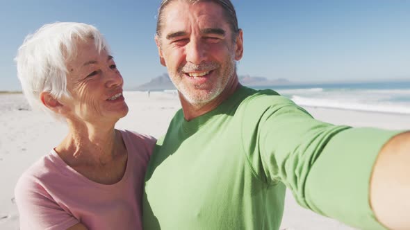 Senior Caucasian couple enjoying time at the beach alt