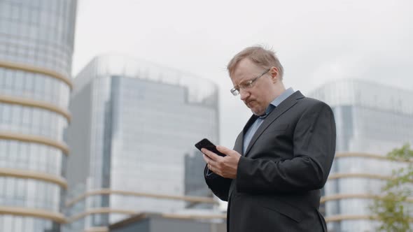 Man Texting on Smartphone, Adult Manager or Businessman Have Difficulties Using Mobile Device alt