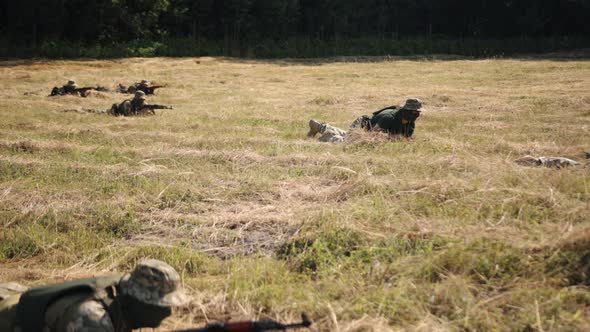 Military Special Forces Unit Soldiers with Weapons Ammunition are on Battlefield Attacking Enemy alt