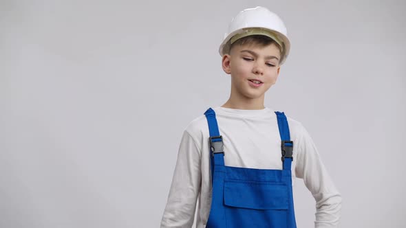 Positive Confident Boy Hanging Builder Uniform on Shoulder Sighing Smiling Looking at Camera alt