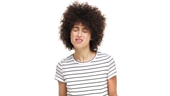Indoor Portrait of Aggressive Young Curly Woman in Casual Tshirt Gesturing in Confrontation Sorting alt