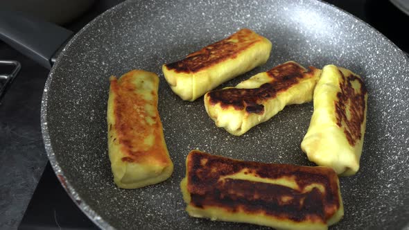 Fried Pancakes With Apples In A Pan