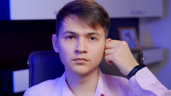 A Young Man Puts on a Digital Hearing Aid alt