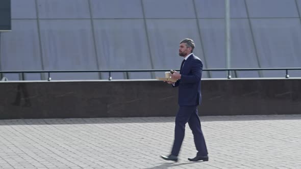 Businessman having snack on foot