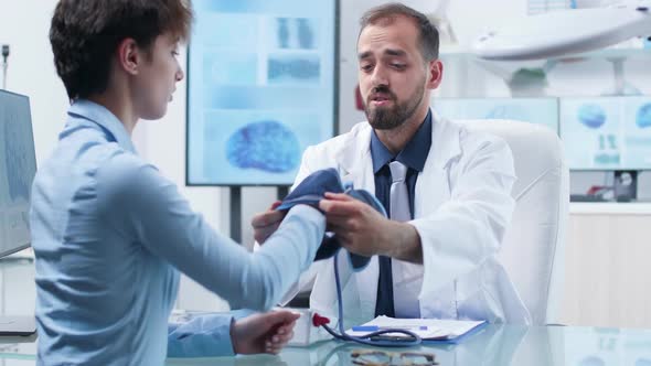 Researcher Measuring Blood Pressure To a Young Female Candidate alt