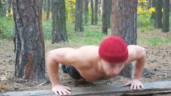 Portrait of Strong Man Doing Push Ups in Forest alt