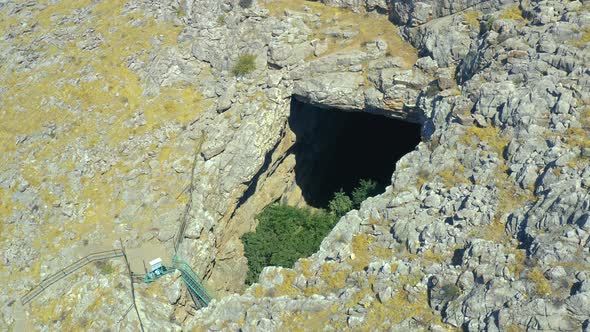 Big Hole Ak Mechet Cave with Trees Inside in Kazakhstan Mountain alt