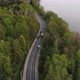 Twolane Road Stretches in Lush Forest with Trees Near River - VideoHive Item for Sale