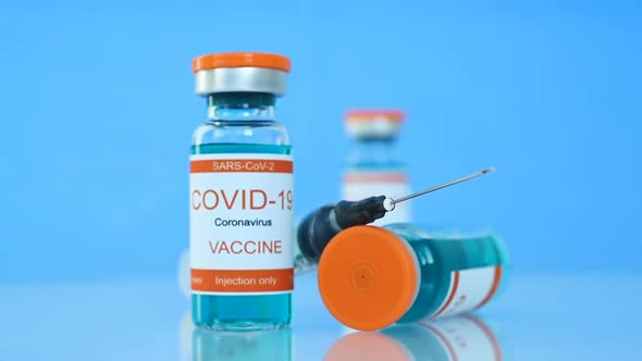 Glass Bottles With Covid-19 Vaccine And Syringe Injection.