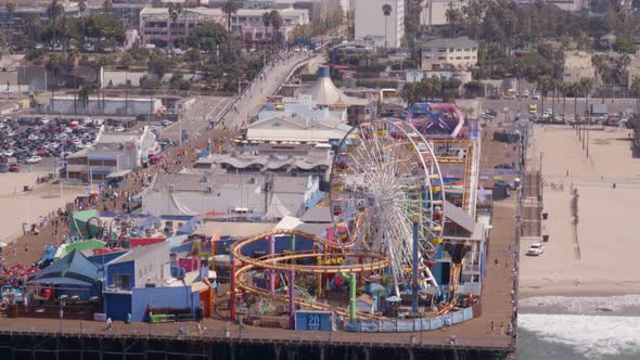 Aerial of Ferris wheel and amusement park rides at Pacific Park alt