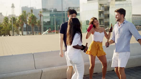 Multiracial Young People Dancing on Warm Summer Day Outdoors with Beer Bottles in Hands alt