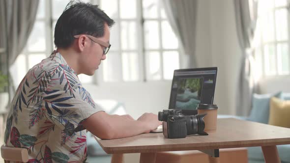 Photographer Works In Photo Editing App / Software On His Laptop Computer alt