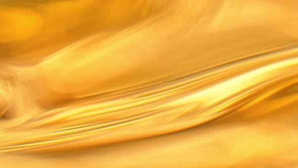 Super Slow Motion Abstract Shot of Waving Golden Oil Background at 1000Fps alt