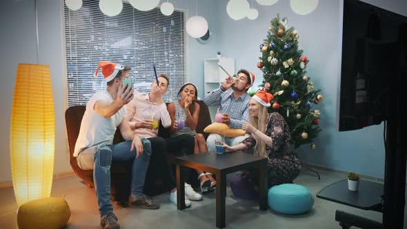 Young Mixed Race People in Santa Hats Making Video Call By Smartphone on Christmas Party alt