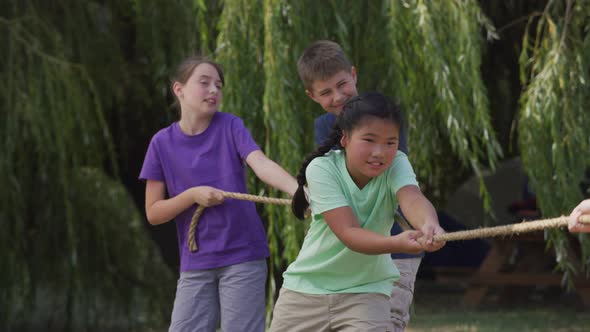 Kids at summer camp playing tug or war