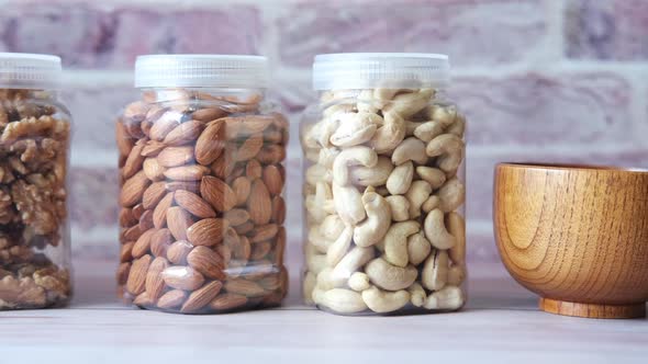 Walnut  Cashew Nut and Almond in a Container on Table alt