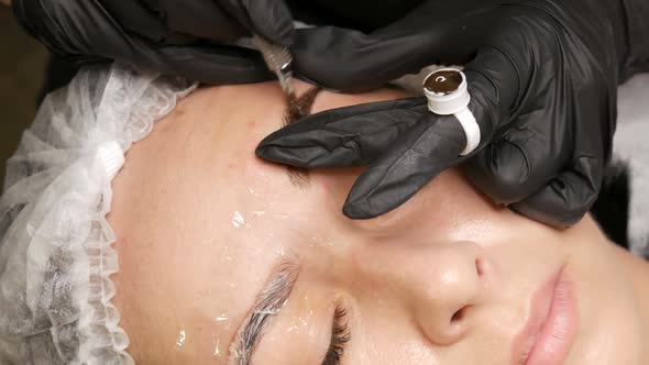 The Master Applies a Special Dark Pigment for Coloring Eyebrows