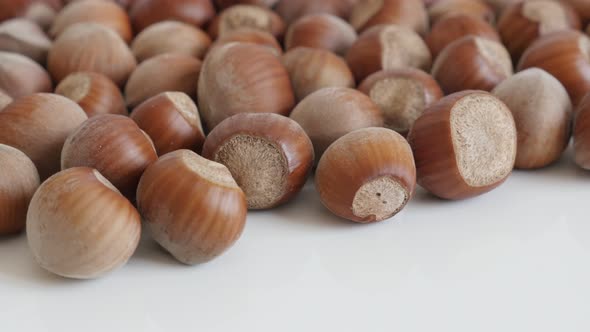 Close-up of Corylus avellana organic nuts  4K 2160p 30fps UltraHD tilting footage - Whole hazelnuts  alt