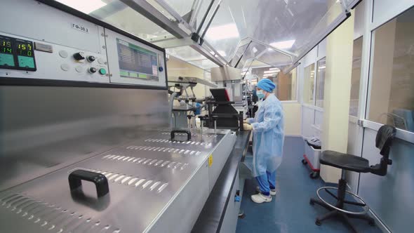 Pharmaceutical Worker Examines and Controls the Production Line
