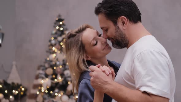 Happy Young People Are Dancing Near the Christmas Tree alt