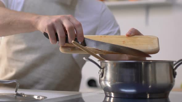Man Adding Cropped Bell Pepper Into Pan and Stirring, Cooking Vegetable Stew alt