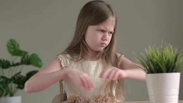 Sad Kid Girl Holding Two Pieces of Red Paper Heart alt